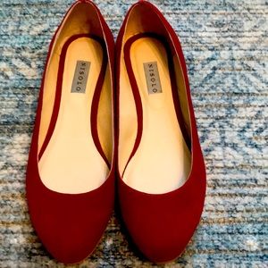 Red suede Nisolo shoes.